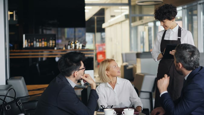 Server enhancing the dining experience in a restaurant